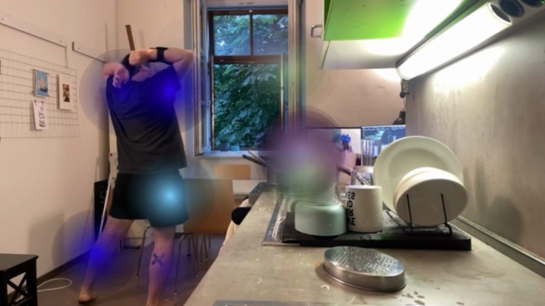 The performer moving at home, overlaid with coloured blurred traces generated by the motion_repo app.